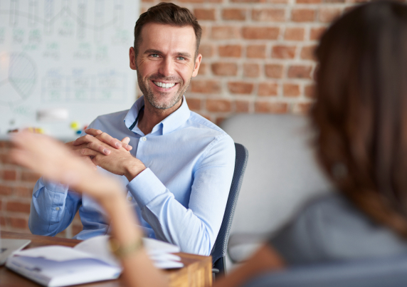 Man smiles in interview